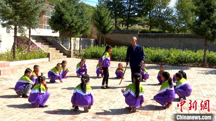 图为盛清章拄着拐棍和学生互动。 赵琦 摄 图为盛清章拄着拐棍和学生互动。 赵琦 摄