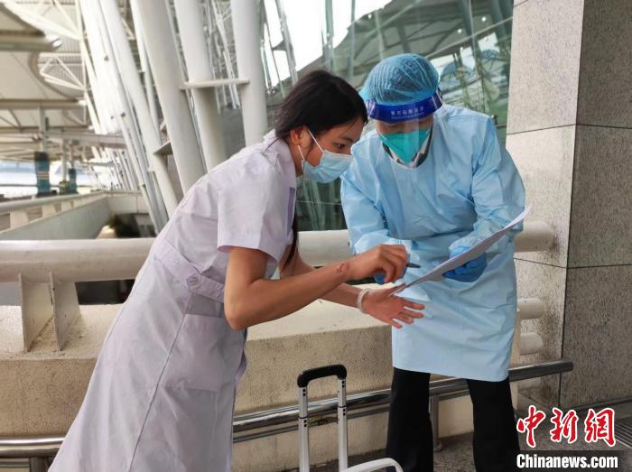 广州白云机场航空运送服务分公司工作人员与医务人员交接 陈佳 摄 广州白云机场航空运送服务分公司工作人员与医务人员交接 陈佳 摄