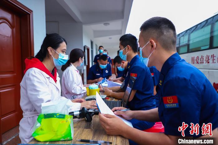 医护人员向消防员说明献血注意事项。　李袁辉 摄